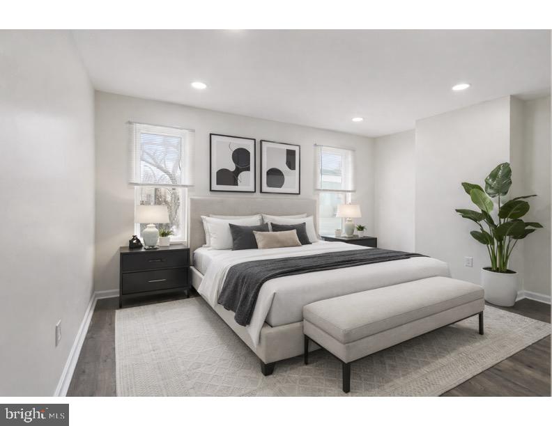 1840 North Taylor Street Philadelphia, PA 19121 - Photo 20 of 29 a spacious bedroom with a bed and a couch