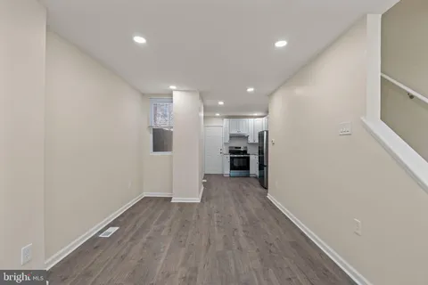 a view of a kitchen with a sink and a refrigerator