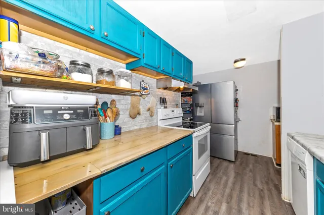 a kitchen with stainless steel appliances a stove a refrigerator and a sink
