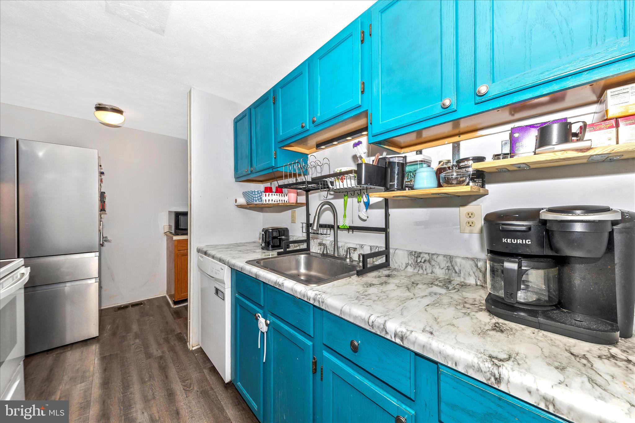 7129 Limestone Lane Middletown, MD 21769 - Photo 12 of 37 a kitchen with stainless steel appliances granite countertop a sink a stove and a wooden floors