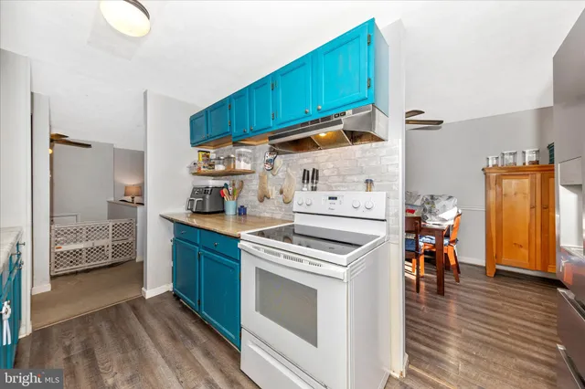 a kitchen with a refrigerator and a stove top oven