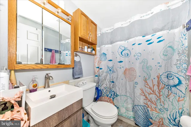 a white toilet sitting next to a bathroom sink