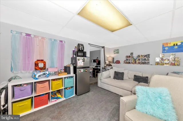 a living room with furniture and a book shelf
