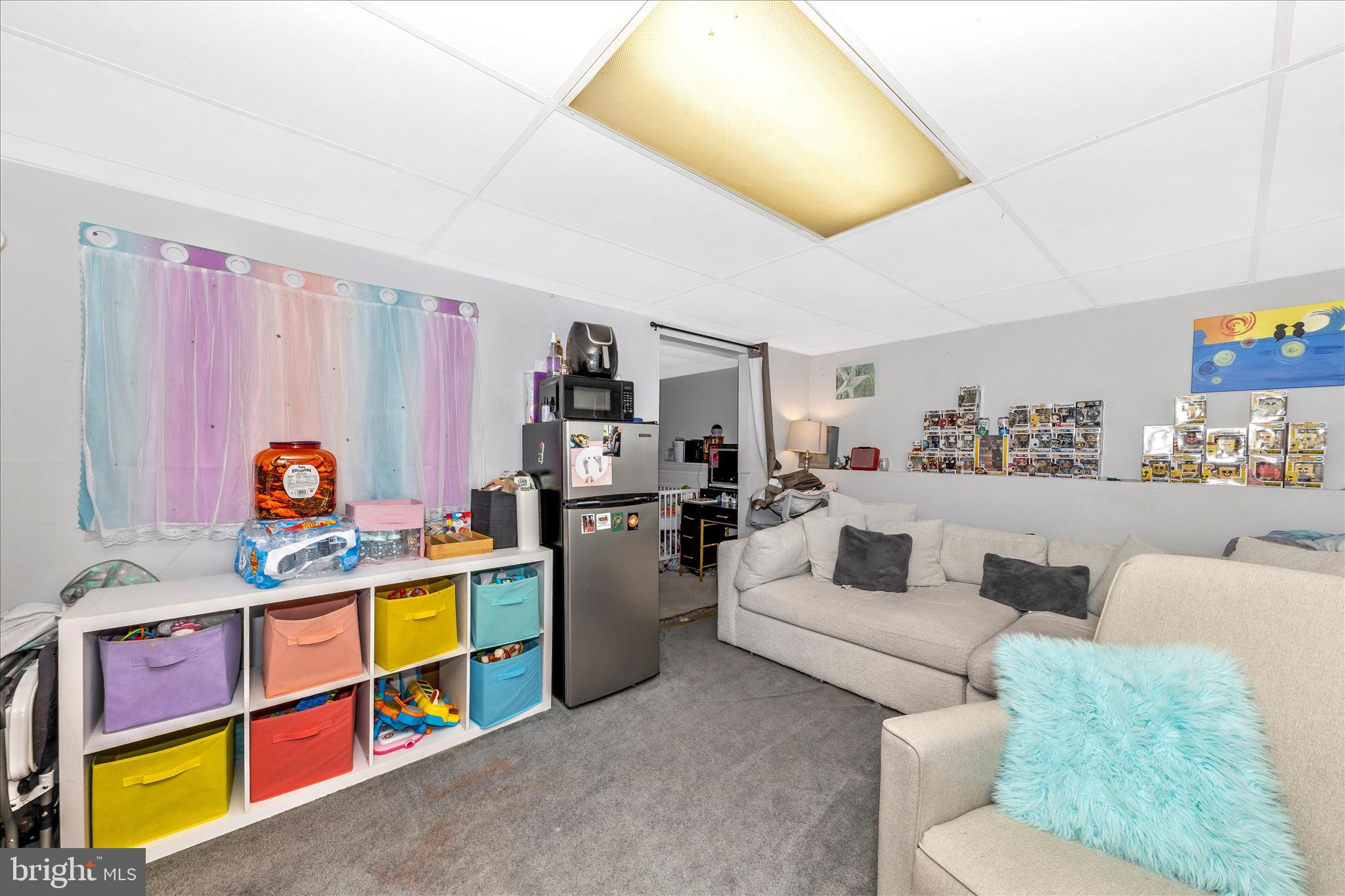 7129 Limestone Lane Middletown, MD 21769 - Photo 25 of 37 a living room with furniture and a book shelf