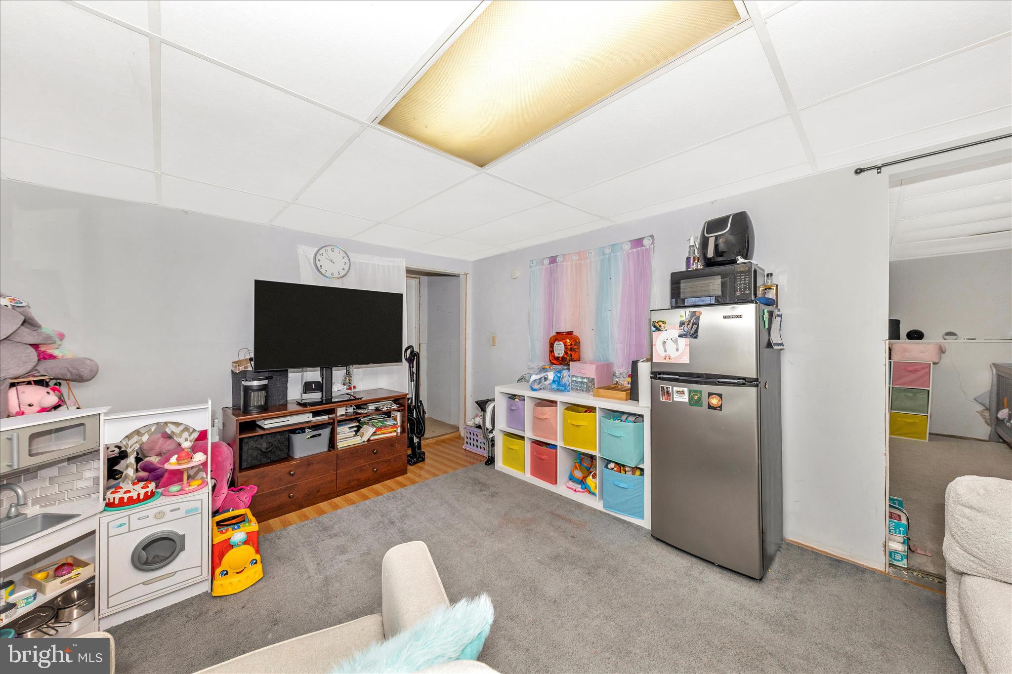 7129 Limestone Lane Middletown, MD 21769 - Photo 27 of 37 a living room with furniture and a flat screen tv
