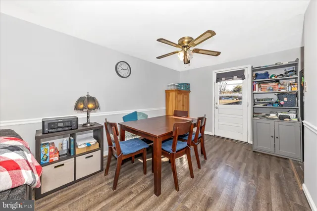 a dining room with a wooden table and chairs