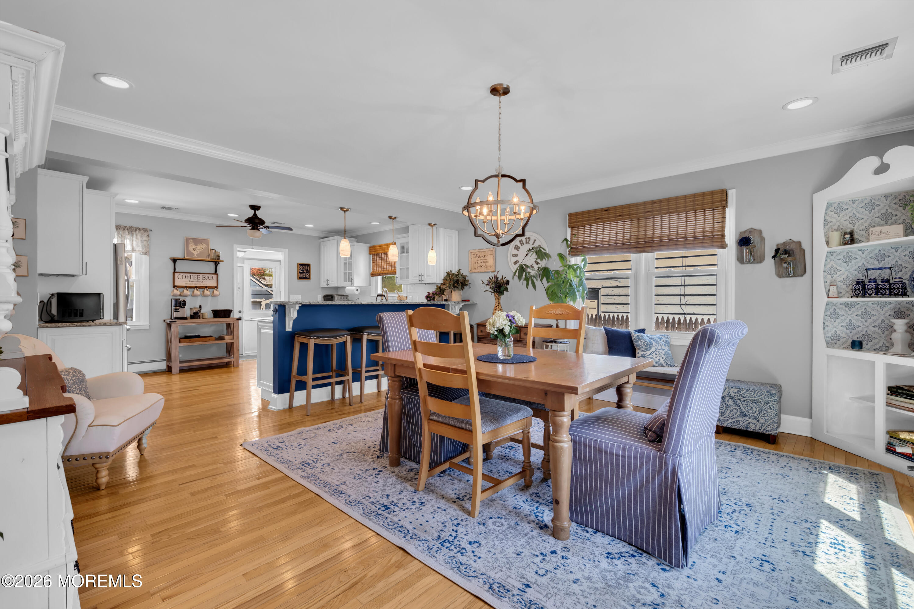 177 Navesink River Road Red Bank, NJ 07701 - Photo 15 of 48 a view of a dining room and livingroom with furniture wooden floor a rug a fireplace and a chandelier