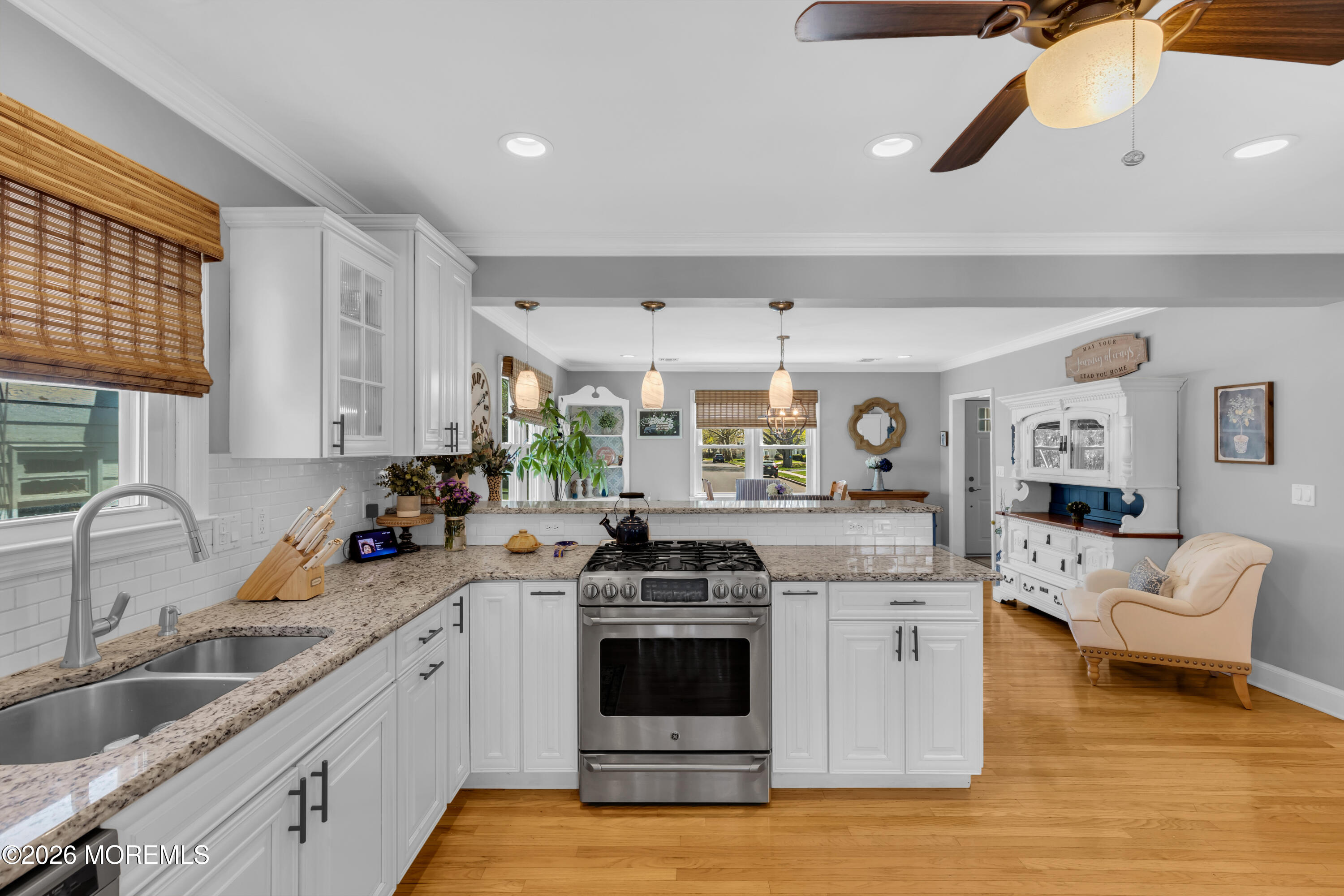 177 Navesink River Road Red Bank, NJ 07701 - Photo 25 of 48 a kitchen with a sink dishwasher a stove a microwave oven and a dining table with wooden floor