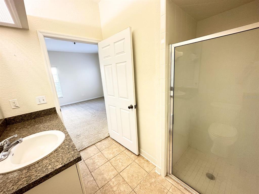 201 Eagle Pond Drive Winter Haven, FL 33884 - Photo 6 of 13 a bathroom with a granite countertop sink and a mirror