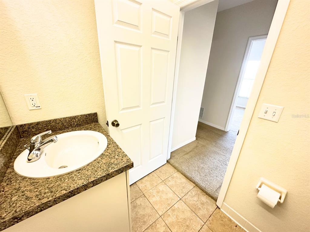 201 Eagle Pond Drive Winter Haven, FL 33884 - Photo 10 of 13 a bathroom with a granite countertop sink and a mirror