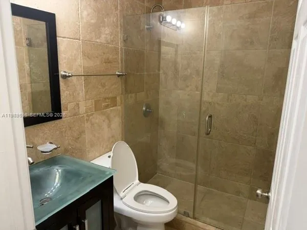 a bathroom with a toilet a sink and shower