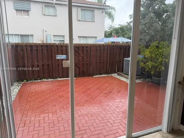 a backyard of a house with a small yard and wooden fence