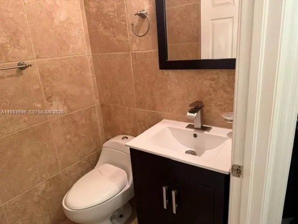 a bathroom with a sink toilet and mirror