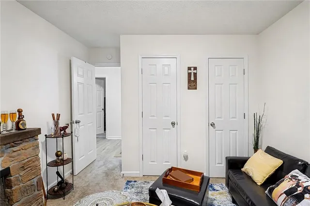a living room with furniture and a book shelf