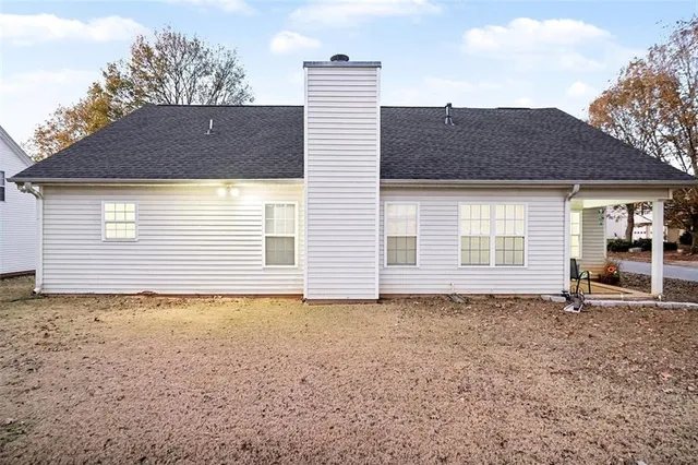 a view of a house with a tree in front