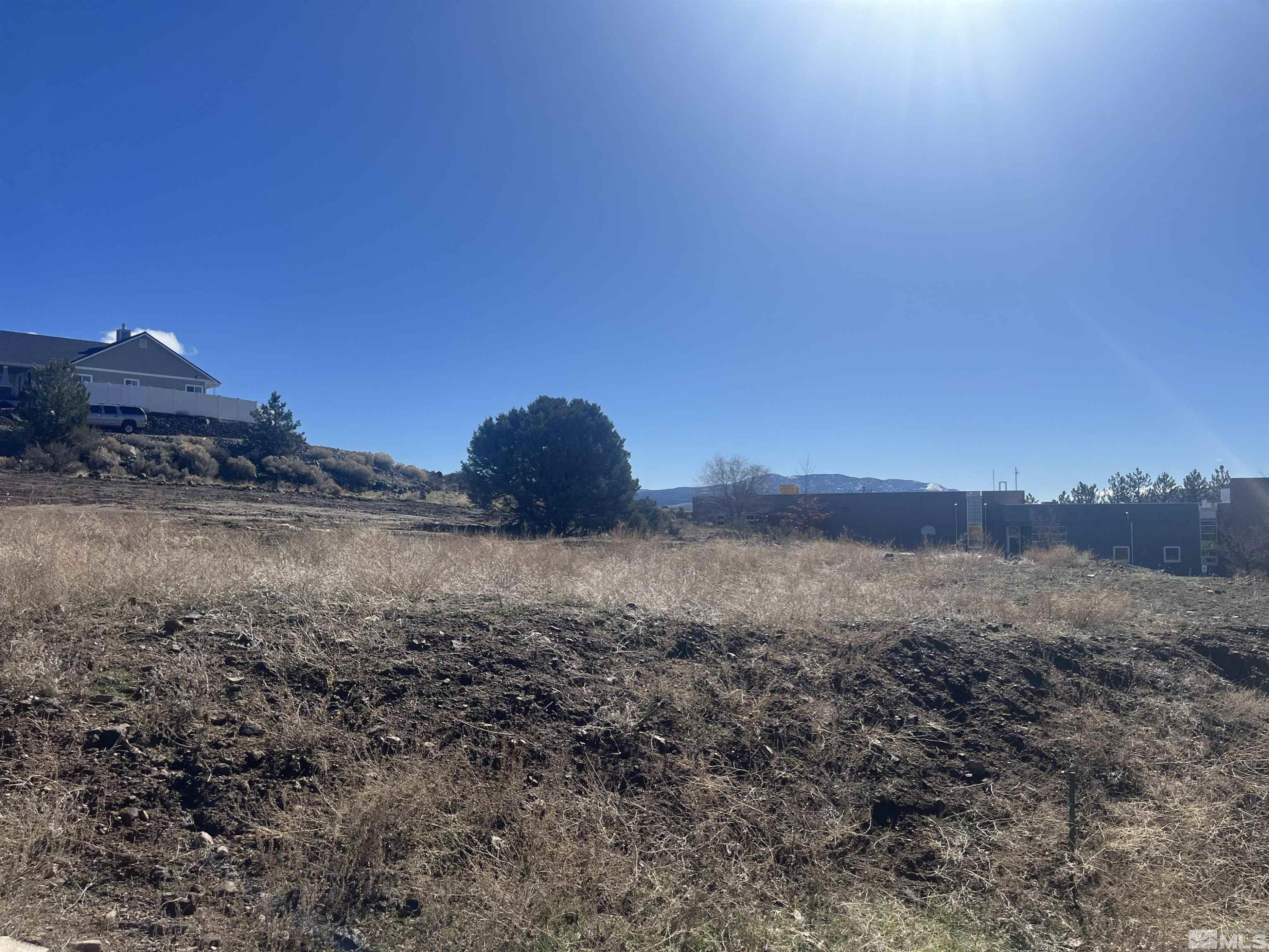 Danielle Drive, Unit SIGSTROM Carson City, NV 89706 - Photo 3 of 4 a view of a dry yard with wooden fence and a mountain view