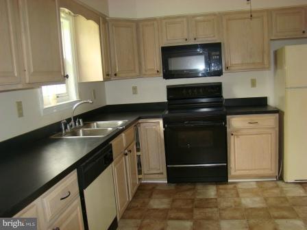 3370 Malcolm Road Brandywine, MD 20613 - Photo 1 of 19 a kitchen with stainless steel appliances a stove a microwave a sink and cabinets