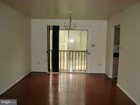 3370 Malcolm Road Brandywine, MD 20613 - Photo 6 of 19 an empty room with wooden floor and windows