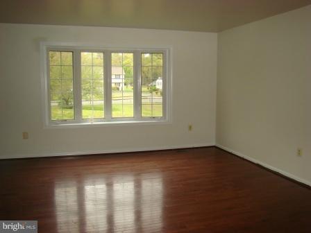 3370 Malcolm Road Brandywine, MD 20613 - Photo 9 of 19 an empty room with wooden floor and windows