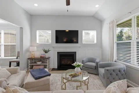 a living room with furniture a flat screen tv and a fireplace