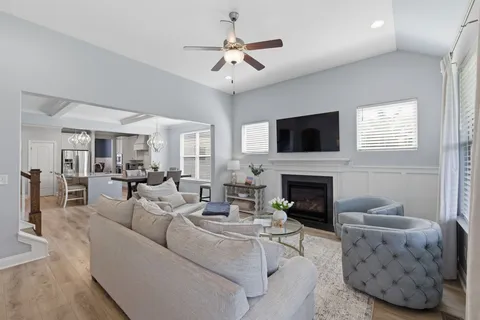 a living room with furniture a fireplace and a flat screen tv