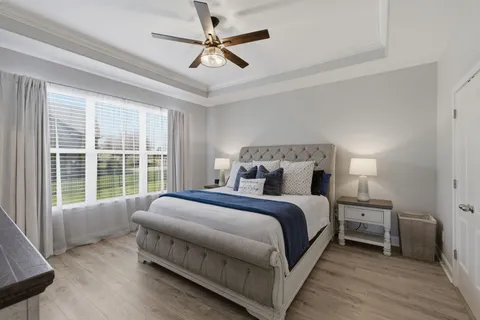 a bedroom with a large bed and a large window