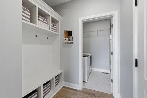 a view of a hallway with workspace and a bathroom