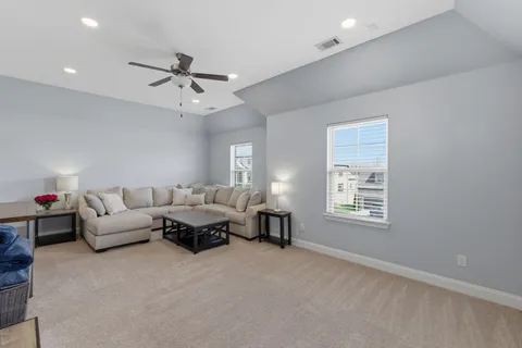 a living room with patio furniture and a floor to ceiling window