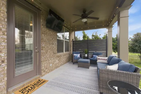 a view of a backyard with plants and large tree