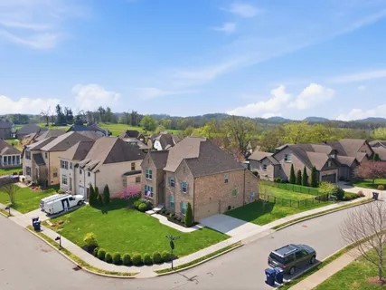 aerial view of a house with a garden and lake view