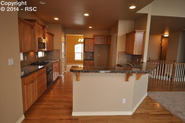 15892 Maple Hill Road Monument, CO 80132 - Photo 7 of 22 Huge breakfast bar and eat in area off kitchen