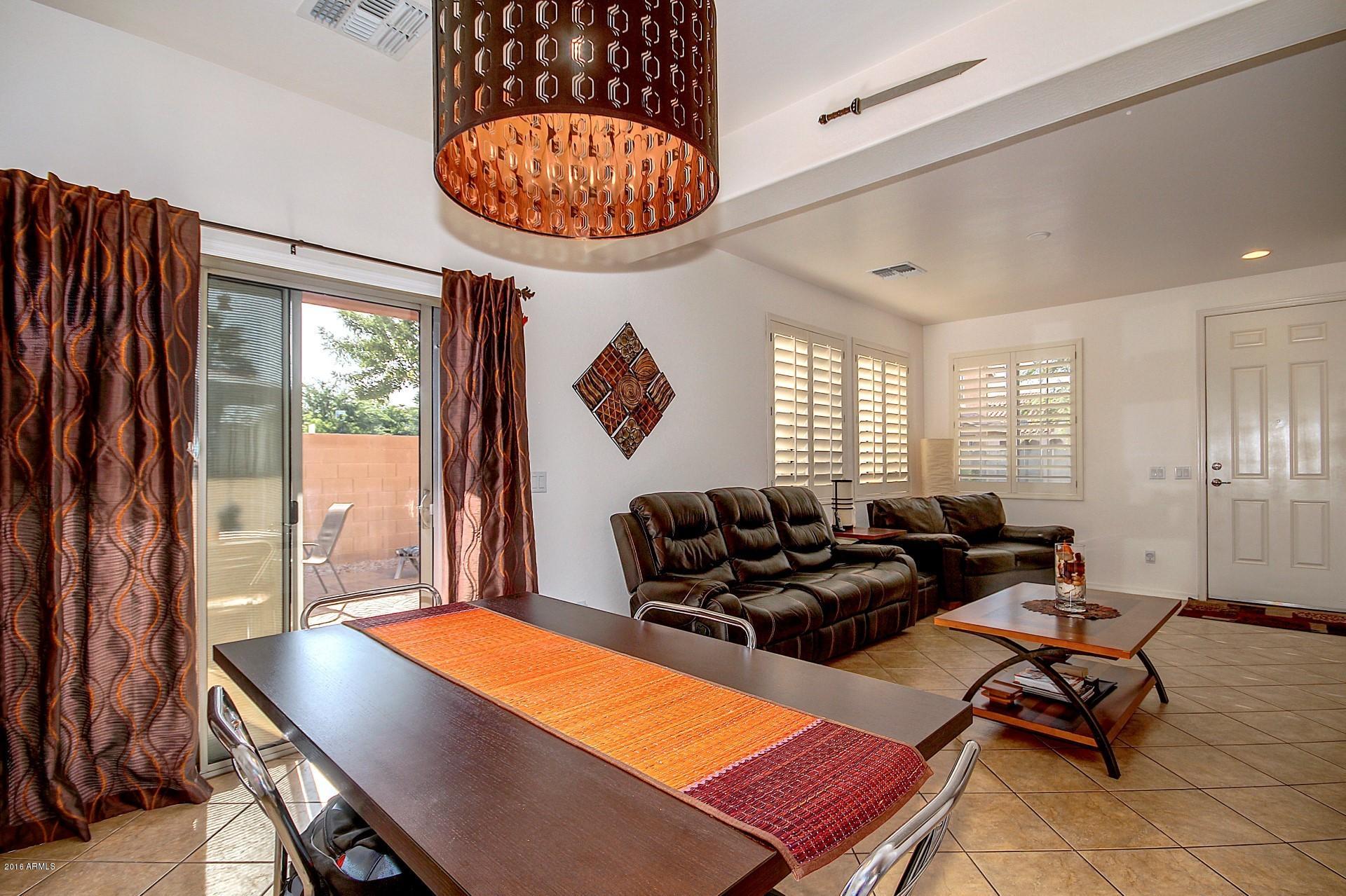 883 East Devon Road Gilbert, AZ 85296 - Photo 12 of 27 a living room with furniture a table and a large window