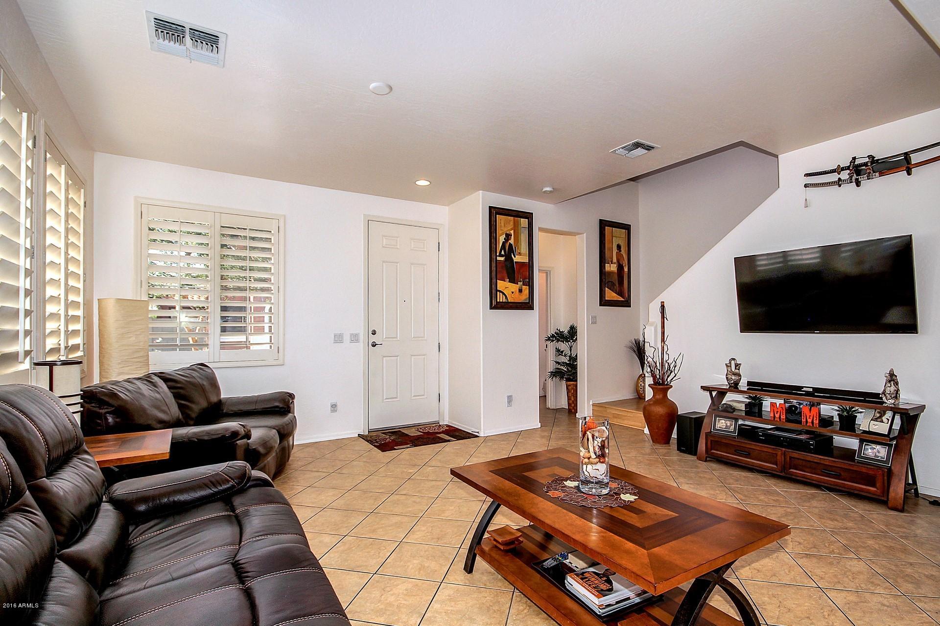 883 East Devon Road Gilbert, AZ 85296 - Photo 13 of 27 a living room with furniture and a flat screen tv