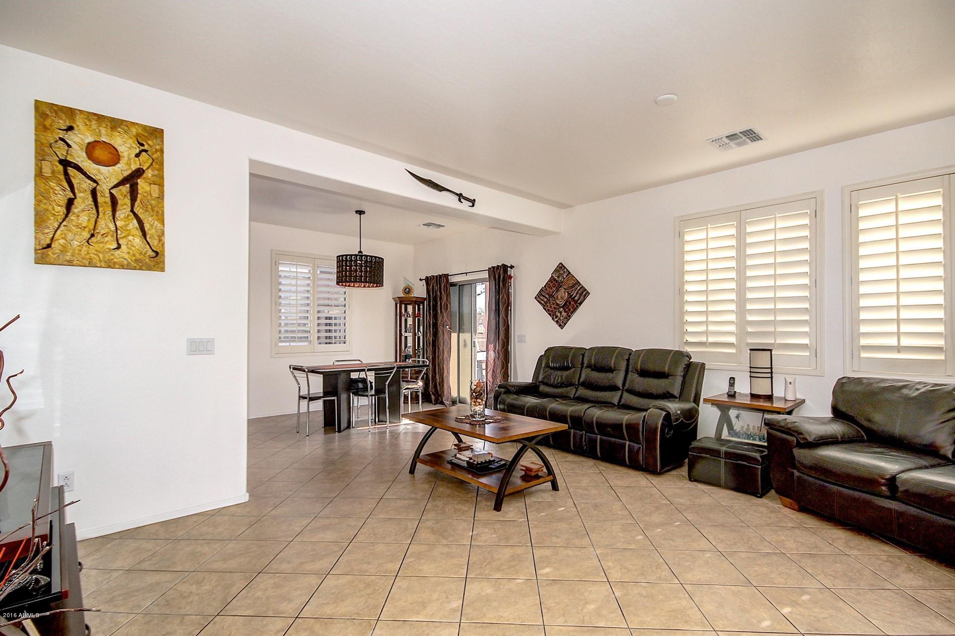 883 East Devon Road Gilbert, AZ 85296 - Photo 14 of 27 a living room with furniture and a large window