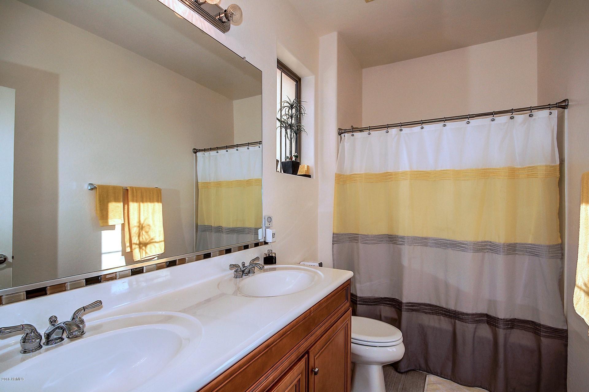 883 East Devon Road Gilbert, AZ 85296 - Photo 18 of 27 a bathroom with a sink a toilet and a mirror