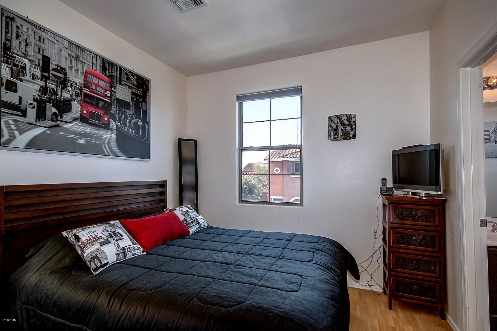 883 East Devon Road Gilbert, AZ 85296 - Photo 19 of 27 a bedroom with a bed and flat screen tv