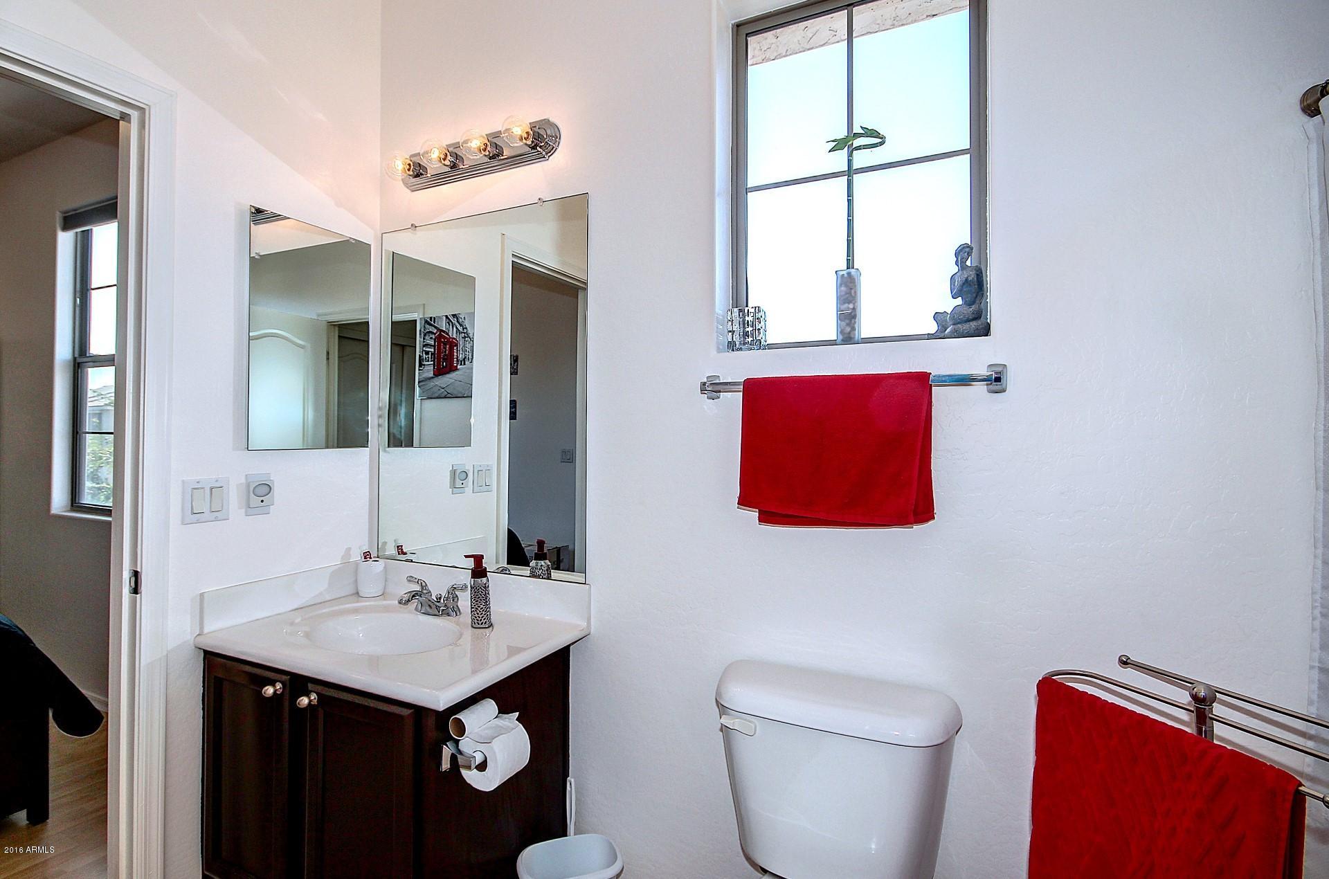 883 East Devon Road Gilbert, AZ 85296 - Photo 22 of 27 a bathroom with a toilet a sink and a mirror