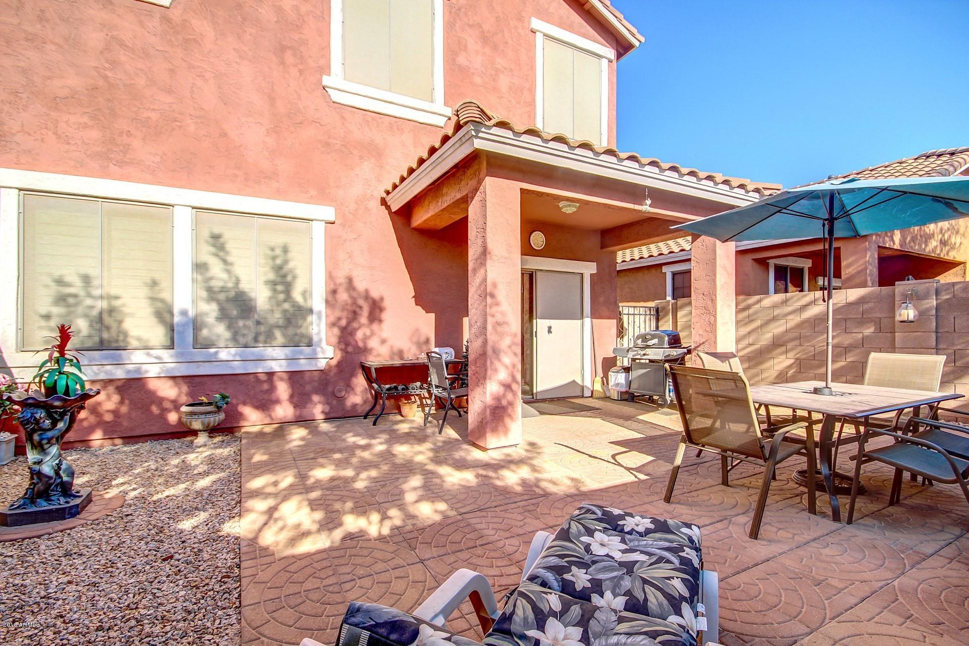 883 East Devon Road Gilbert, AZ 85296 - Photo 25 of 27 a view of a patio with table and chairs and potted plants