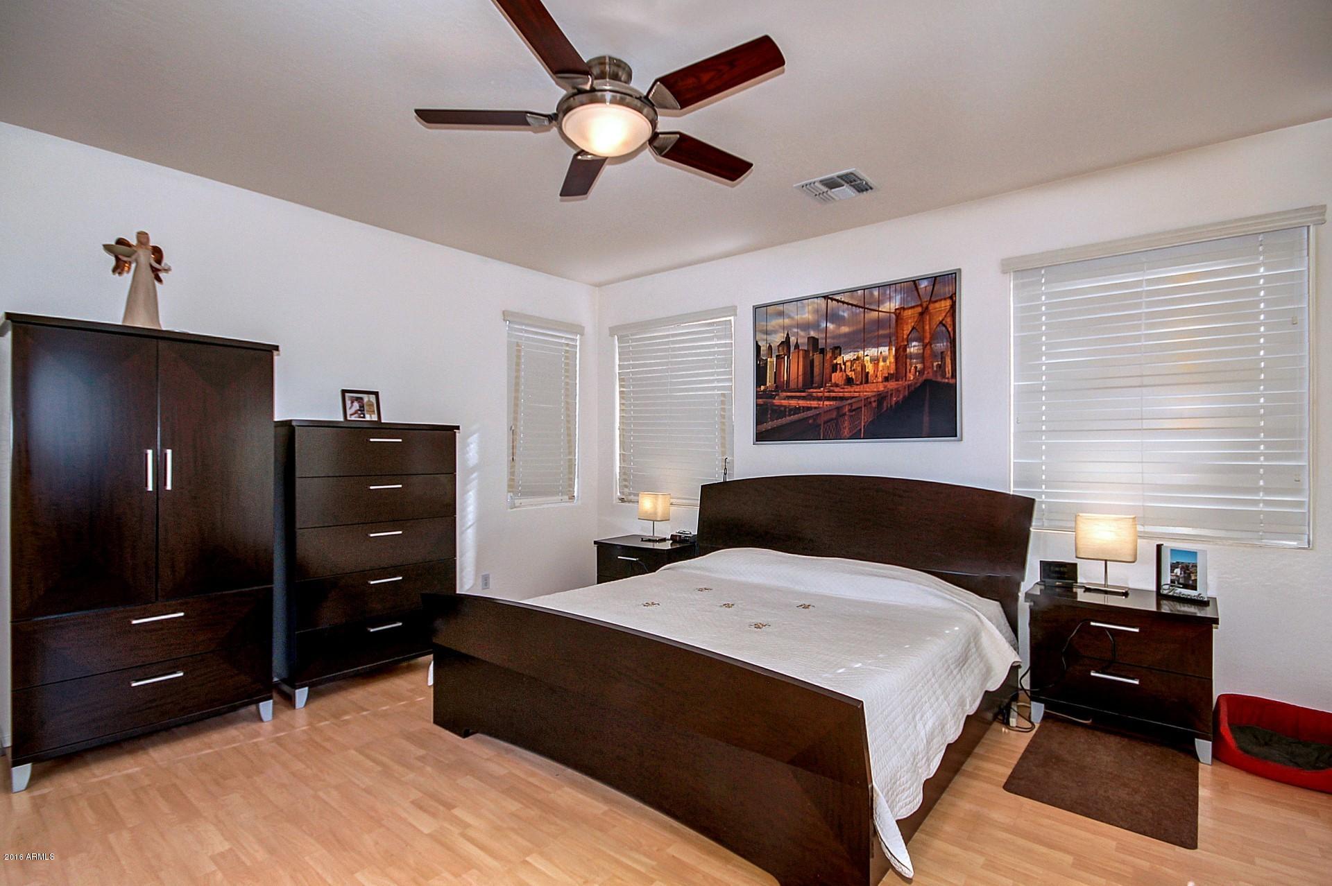 883 East Devon Road Gilbert, AZ 85296 - Photo 4 of 27 a bedroom with a bed and a dresser