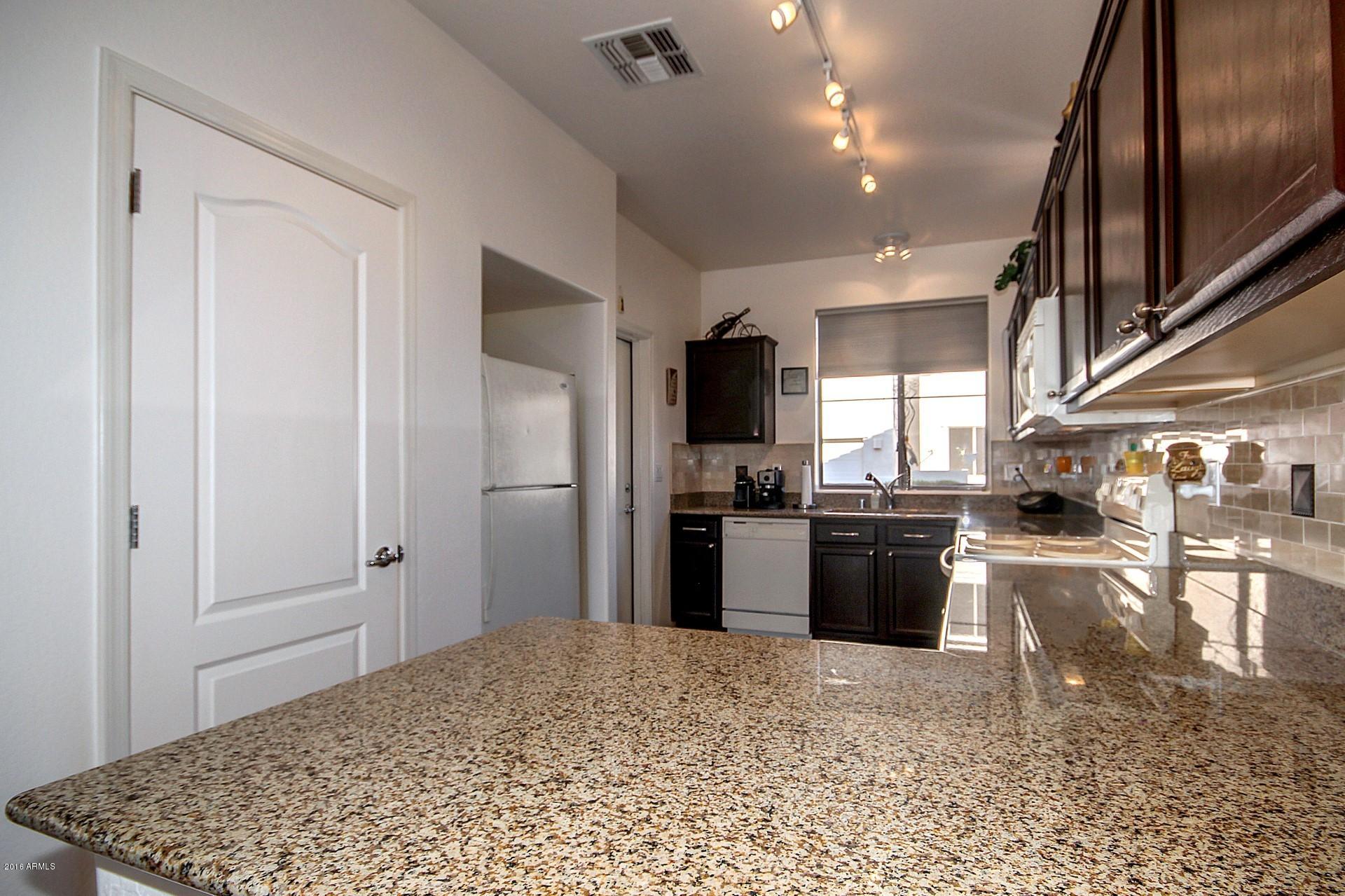 883 East Devon Road Gilbert, AZ 85296 - Photo 9 of 27 a kitchen with stainless steel appliances granite countertop a refrigerator stove and oven
