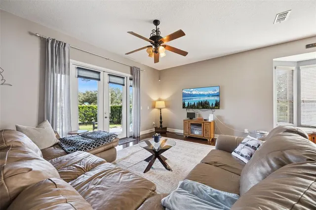 a kitchen with stainless steel appliances kitchen island granite countertop a table chairs and a refrigerator