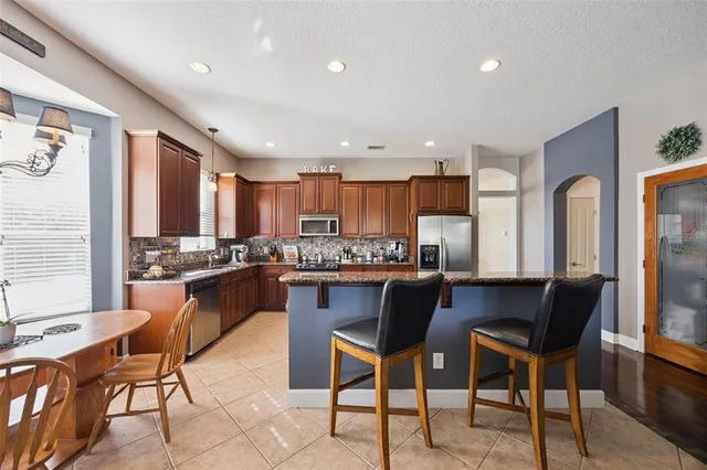 a large kitchen with stainless steel appliances lots of counter top space