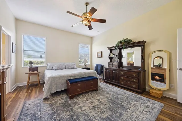 a spacious bedroom with a bed and a chandelier