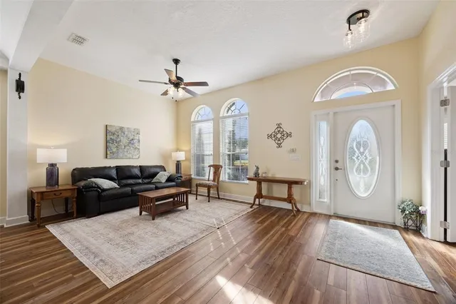 a living room with furniture and wooden floor