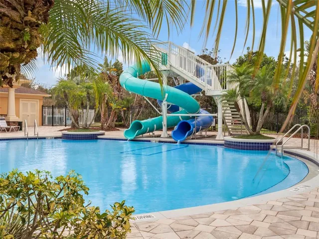 a view of street sign under a large tree