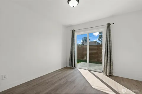a view of a room with wooden floor