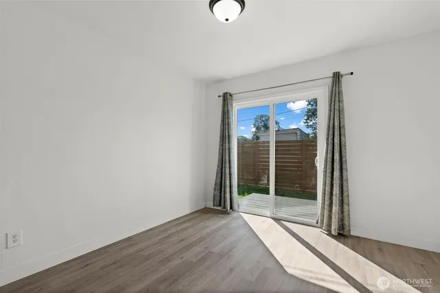 a view of a room with wooden floor