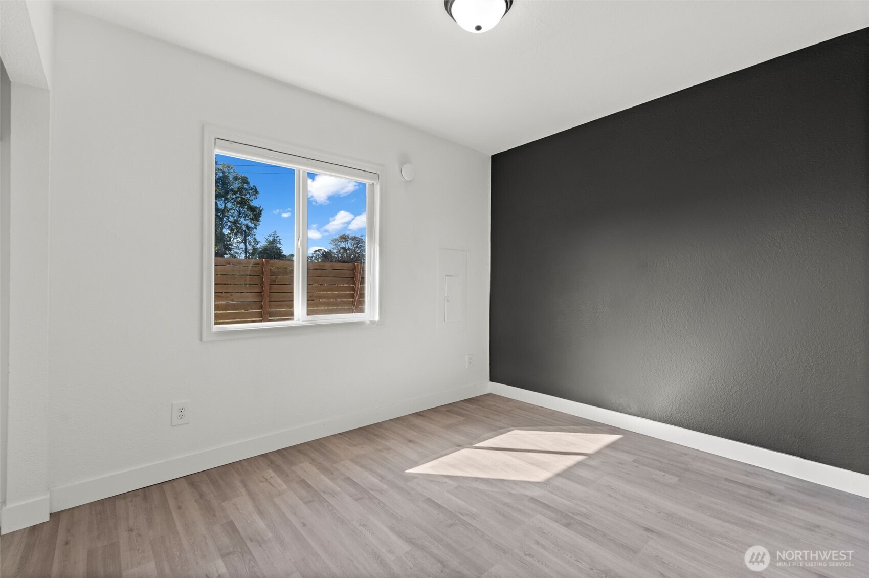 14915 Portland Avenue Southwest Lakewood, WA 98498 - Photo 14 of 29 an empty room with wooden floor and windows