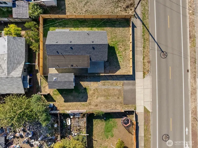 an aerial view of a house with pool and porch