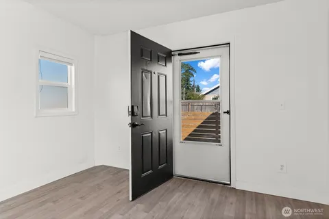 a view of a hallway with wooden floor and stairs